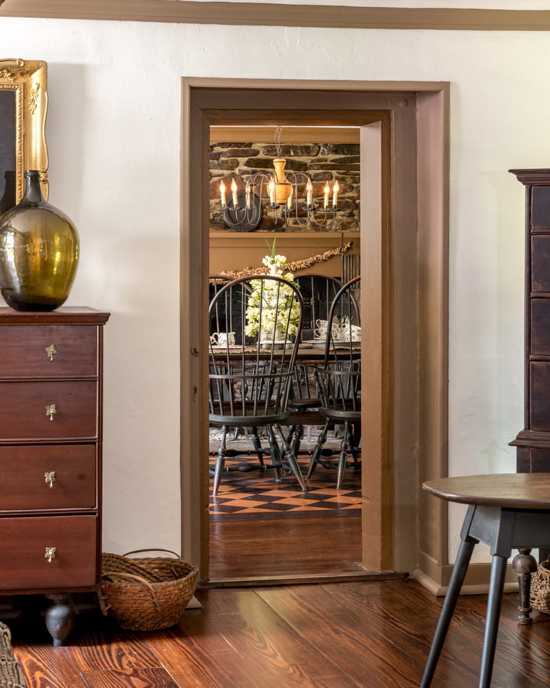 Example of a mid-sized classic dark wood floor enclosed dining room design in Philadelphia with white walls, a standard fireplace and a stone fireplace