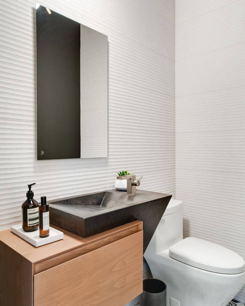 Design ideas for a mid-sized contemporary powder room in Dallas with flat-panel cabinets, light wood cabinets, a one-piece toilet, white walls and wood benchtops.