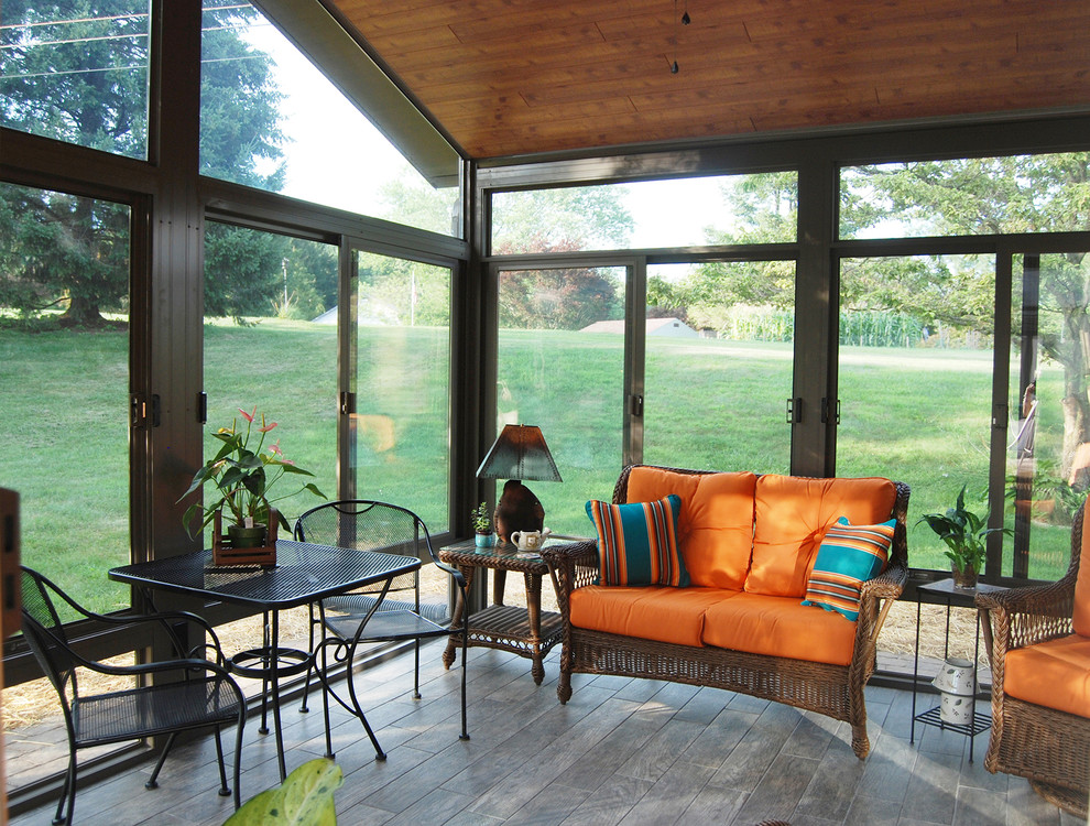 Photo of a large traditional sunroom in Other with porcelain floors, no fireplace, a standard ceiling and grey floor.