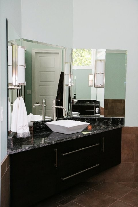 Mid-sized transitional 3/4 brown tile and porcelain tile ceramic tile drop-in bathtub photo in Chicago with flat-panel cabinets, black cabinets, a two-piece toilet, blue walls, a drop-in sink and marble countertops