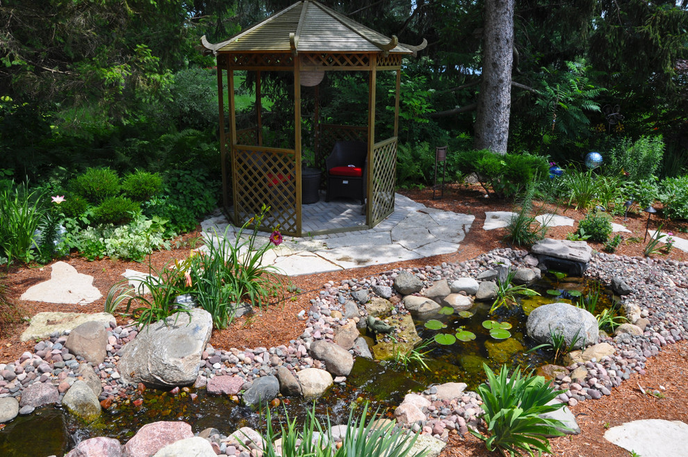 Design ideas for a large asian garden in Other with a water feature and natural stone pavers.