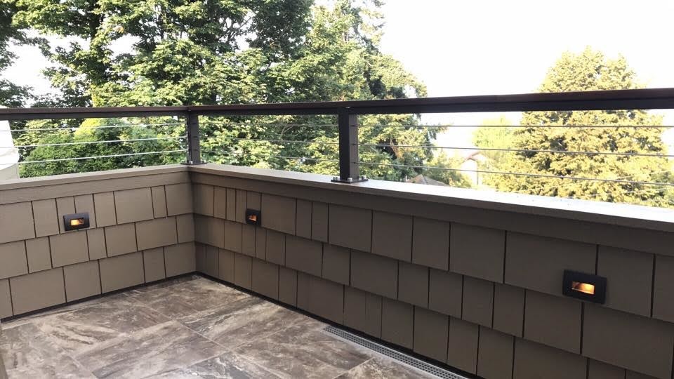 Mid-sized traditional balcony in Seattle with no cover and wood railing.