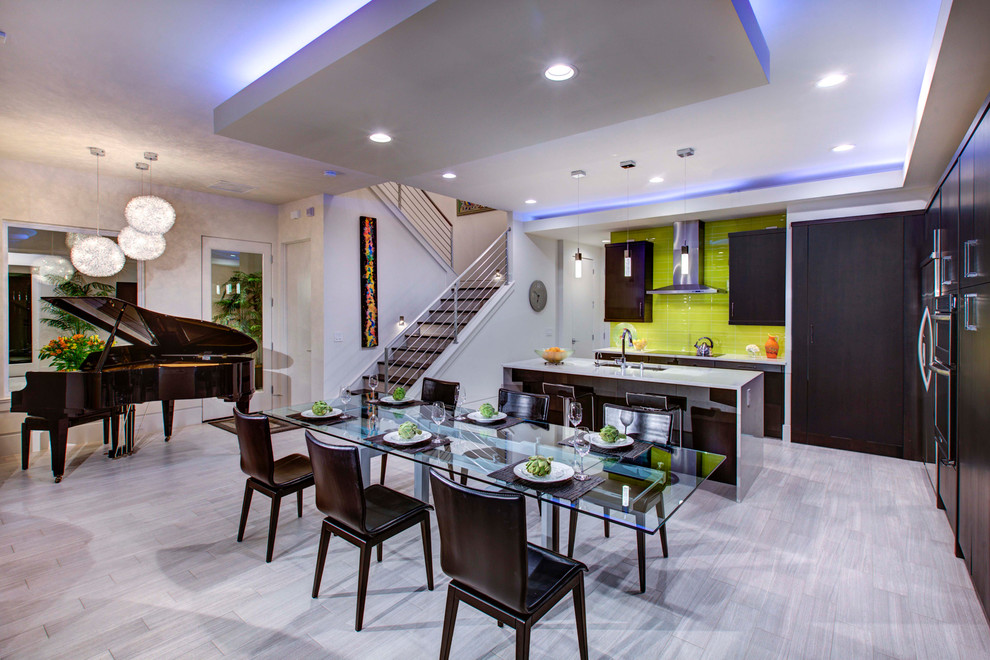 Inspiration for a transitional l-shaped porcelain tile eat-in kitchen remodel in Orlando with green backsplash and an island