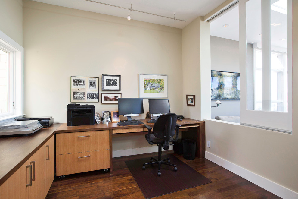 Photo of a large contemporary study room in San Francisco with beige walls, medium hardwood floors and a built-in desk.