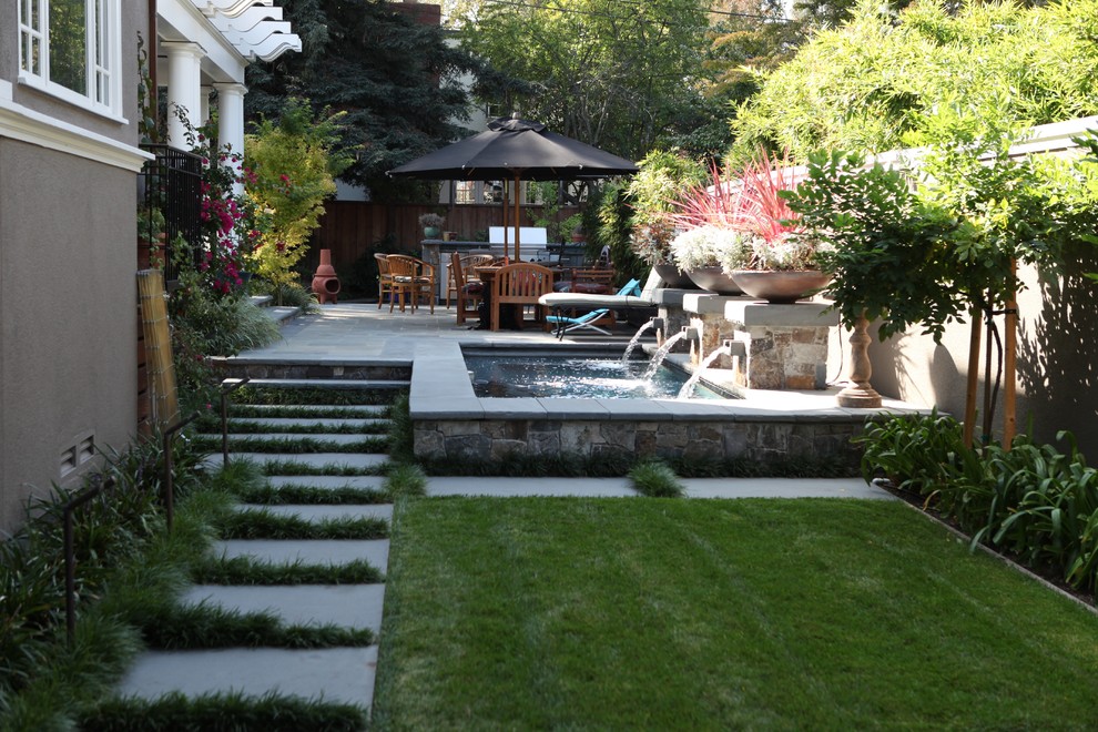 Photo of a mid-sized transitional backyard garden in San Francisco with a water feature.