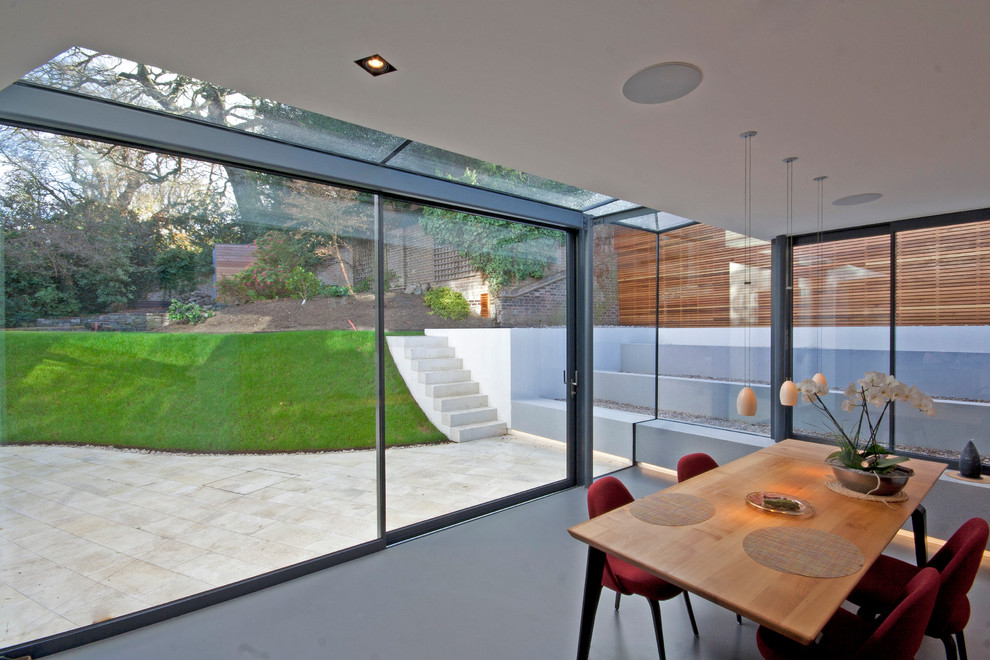 This is an example of a contemporary dining room in London with vinyl floors.