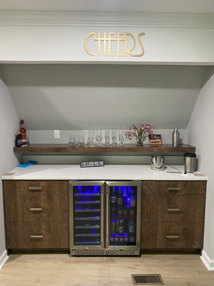 Design ideas for a small modern single-wall home bar in Raleigh with no sink, flat-panel cabinets, dark wood cabinets, quartz benchtops, white splashback, engineered quartz splashback, vinyl floors, brown floor and white benchtop.