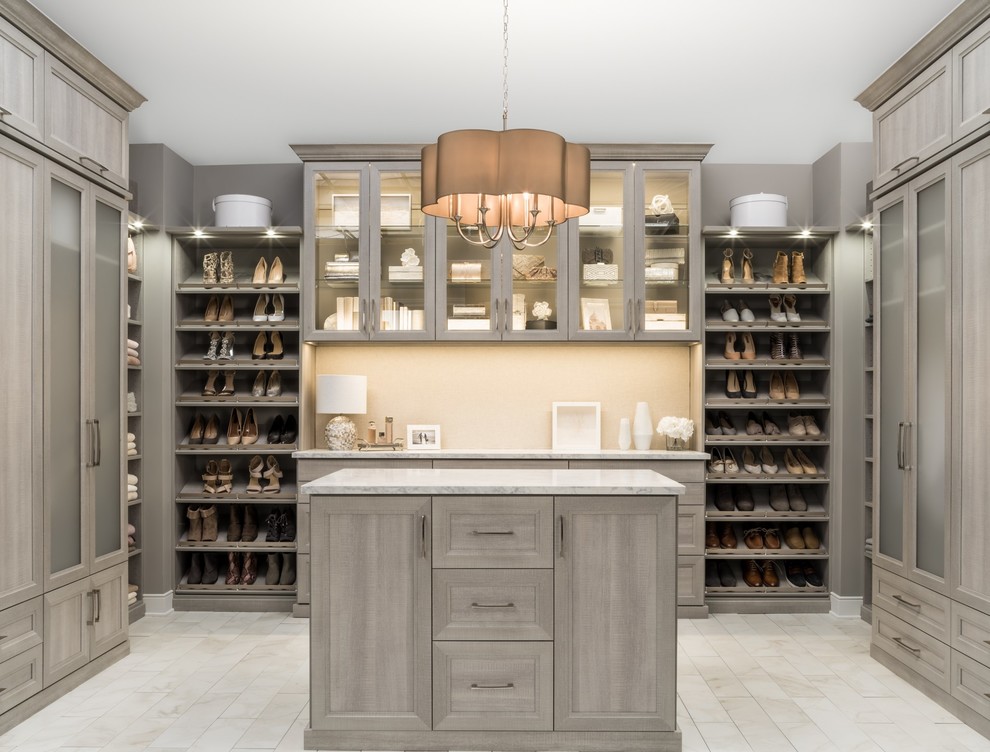 Inspiration for a huge modern gender-neutral beige floor walk-in closet remodel in Chicago with gray cabinets and recessed-panel cabinets