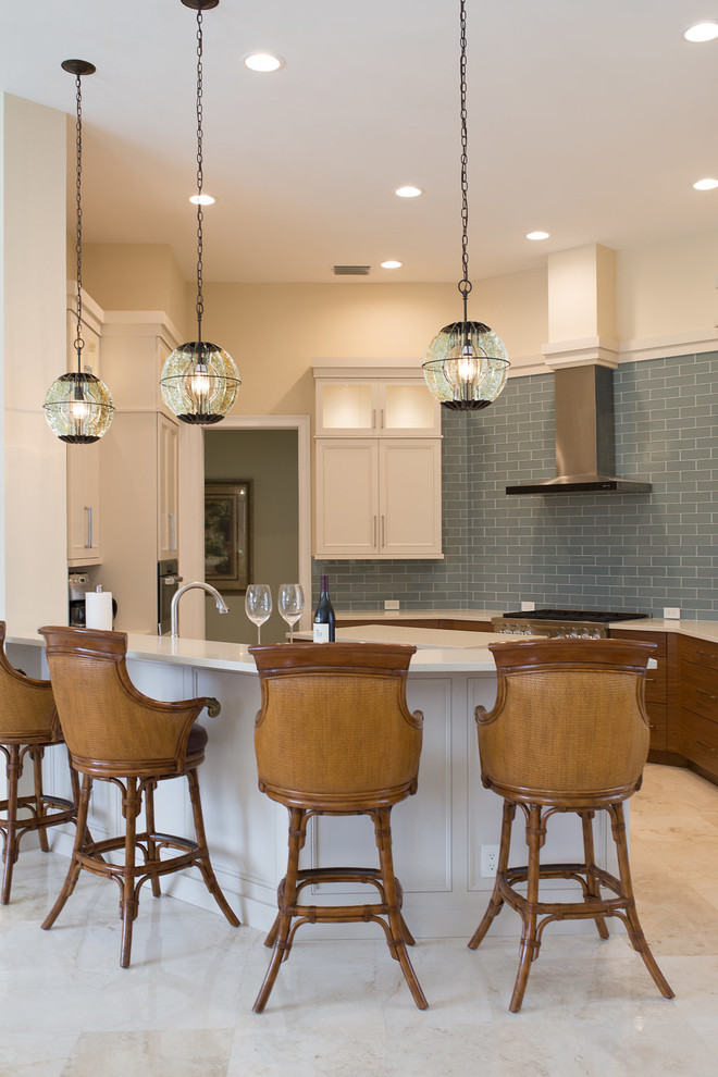 Example of a large transitional u-shaped porcelain tile and beige floor enclosed kitchen design in Miami with an undermount sink, beaded inset cabinets, white cabinets, quartzite countertops, blue backsplash, subway tile backsplash, stainless steel appliances and an island