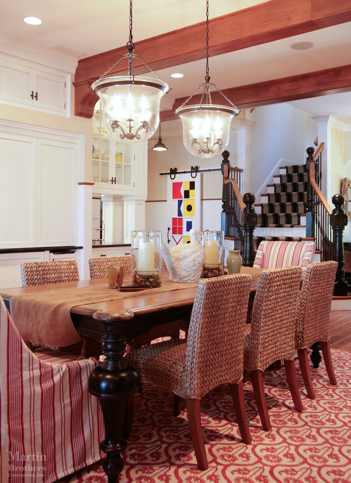 Design ideas for a large traditional open plan dining in Other with yellow walls, medium hardwood floors, a two-sided fireplace, a stone fireplace surround and decorative wall panelling.