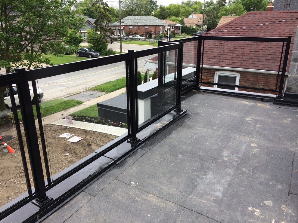 This is an example of a contemporary balcony in Toronto with glass railing.