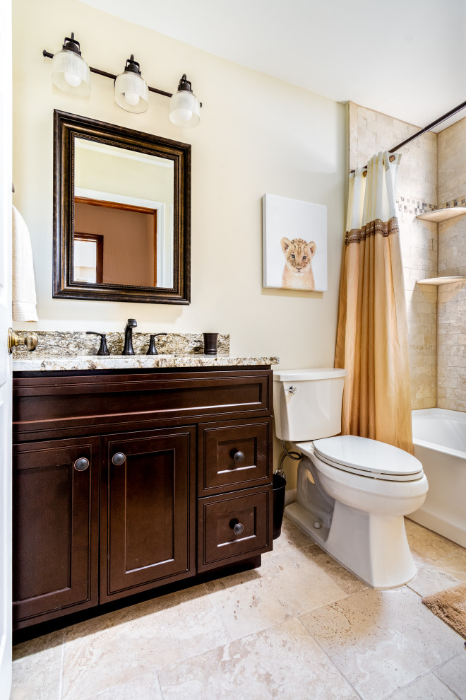This is an example of a small traditional kids bathroom in Philadelphia with shaker cabinets, dark wood cabinets, an alcove tub, an alcove shower, a two-piece toilet, beige tile, ceramic tile, beige walls, ceramic floors, an undermount sink, granite benchtops, beige floor, a shower curtain, brown benchtops, a single vanity and a freestanding vanity.