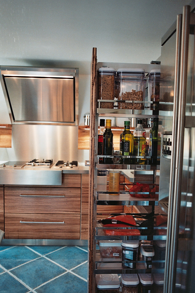 Photo of a mid-sized contemporary l-shaped separate kitchen in Toulouse with medium wood cabinets and no island.