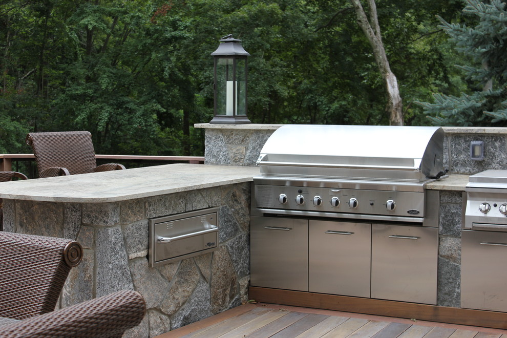 Inspiration for a large transitional backyard deck remodel in Bridgeport with a fire pit and no cover