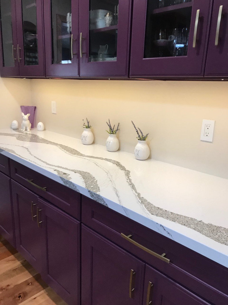 Inspiration for a medium sized classic kitchen in Other with recessed-panel cabinets, purple cabinets, engineered stone countertops, light hardwood flooring, an island, brown floors and white worktops.
