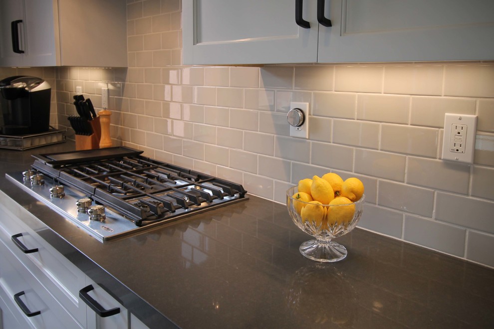 Inspiration for a mid-sized transitional l-shaped porcelain tile open concept kitchen remodel in Sacramento with an undermount sink, shaker cabinets, gray cabinets, quartzite countertops, gray backsplash, ceramic backsplash, stainless steel appliances and an island