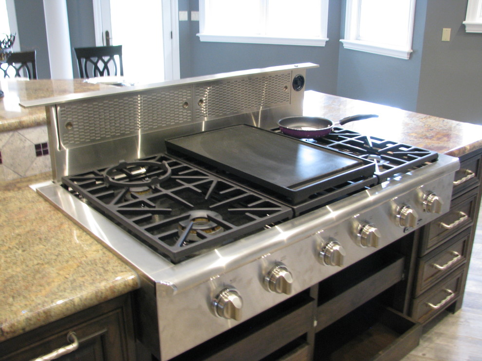 Inspiration for a huge transitional l-shaped porcelain tile open concept kitchen remodel in Phoenix with an undermount sink, raised-panel cabinets, gray cabinets, granite countertops, gray backsplash, stone tile backsplash, stainless steel appliances and an island