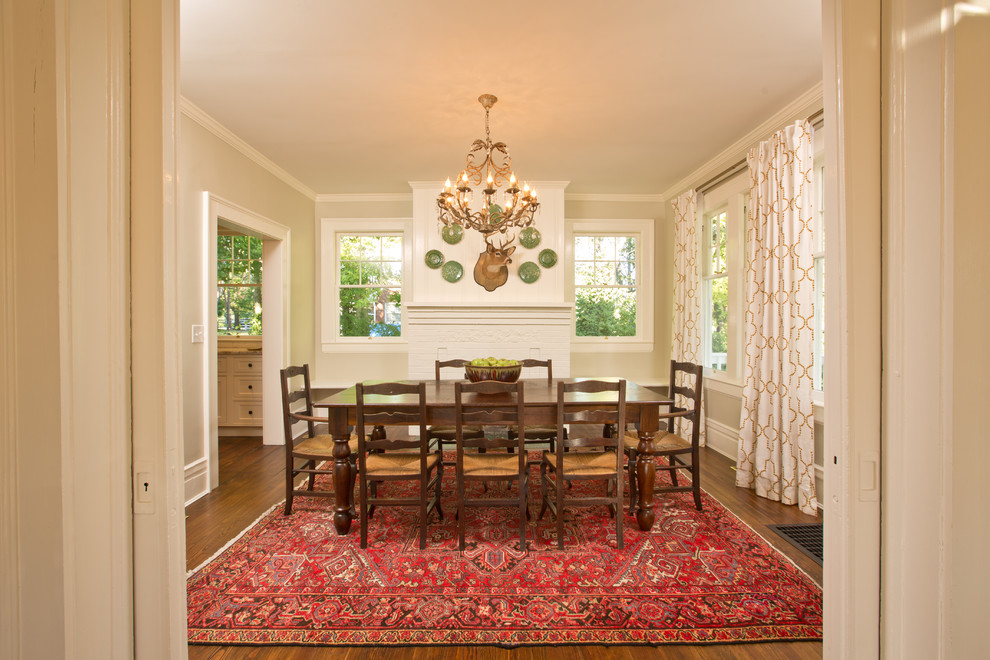 Mid-sized country separate dining room in Other with beige walls, medium hardwood floors, a standard fireplace, a brick fireplace surround and brown floor.