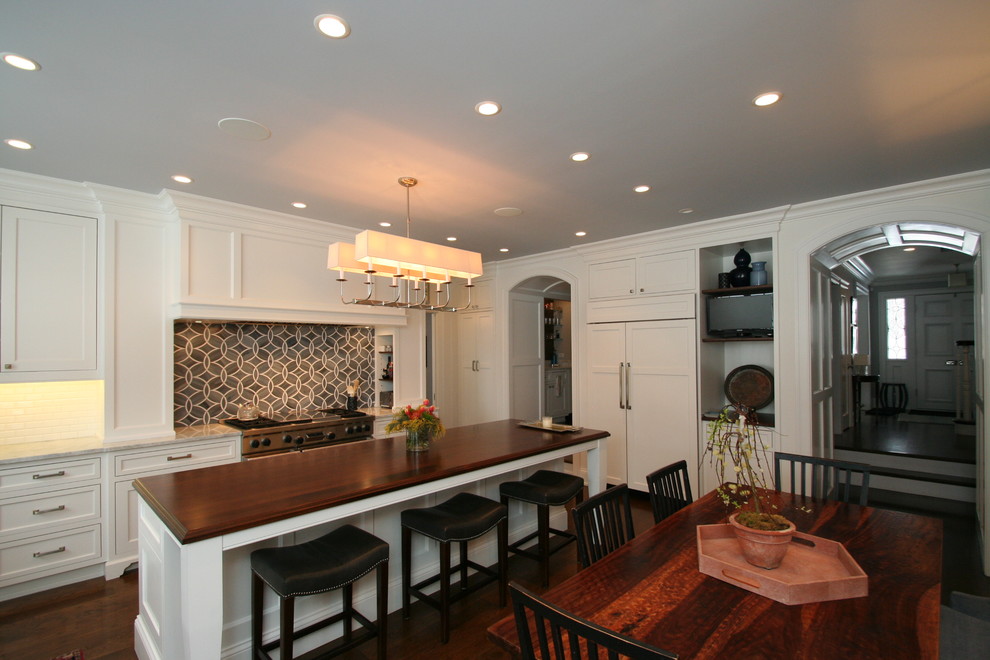 Large transitional l-shaped dark wood floor open concept kitchen photo in Chicago with flat-panel cabinets, white cabinets, granite countertops, blue backsplash, ceramic backsplash, stainless steel appliances and an island