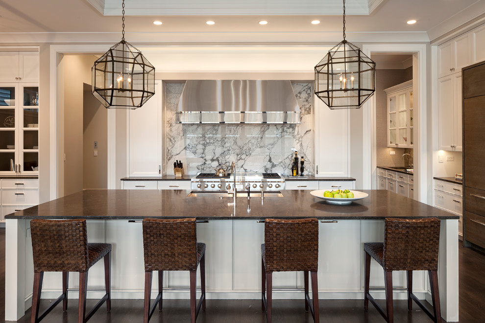 Large transitional l-shaped dark wood floor and brown floor open concept kitchen photo in Chicago with a farmhouse sink, recessed-panel cabinets, white cabinets, marble countertops, multicolored backsplash, marble backsplash, stainless steel appliances and an island