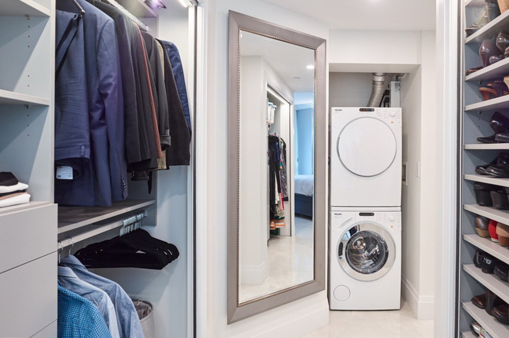 Mid-sized contemporary gender-neutral walk-in wardrobe in Other with shaker cabinets, grey cabinets and white floor.