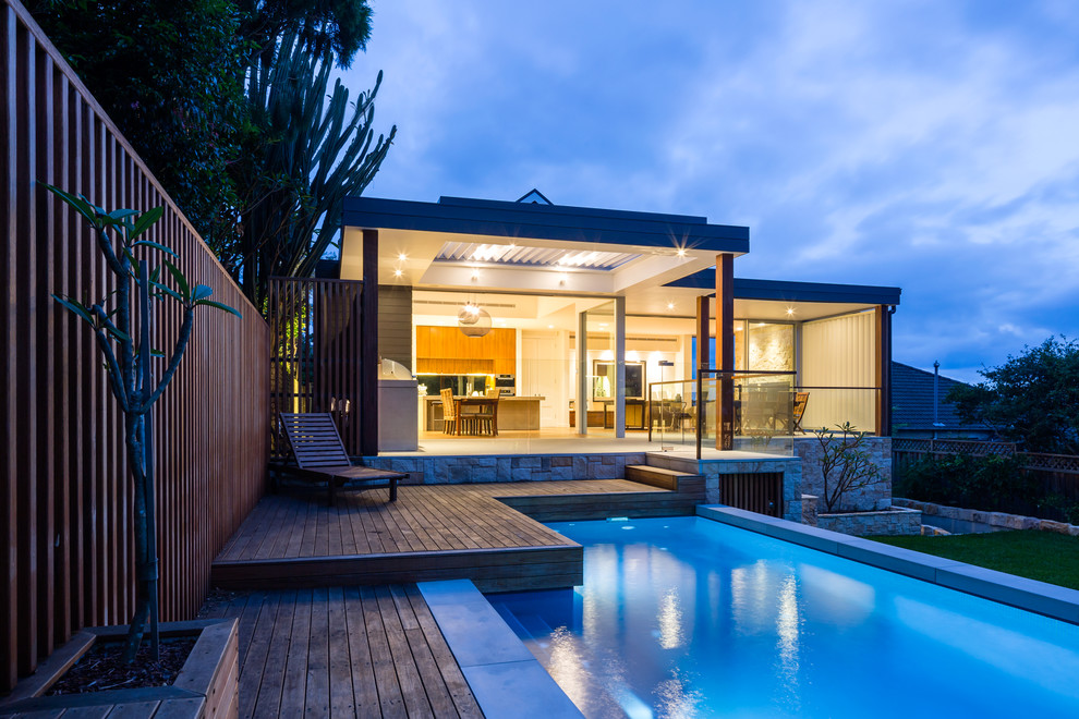 Inspiration for a contemporary house exterior in Sydney with stone veneer and a metal roof.