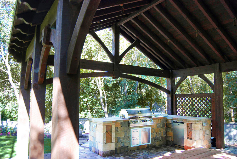 Photo of a country patio in Salt Lake City with an outdoor kitchen and a pergola.