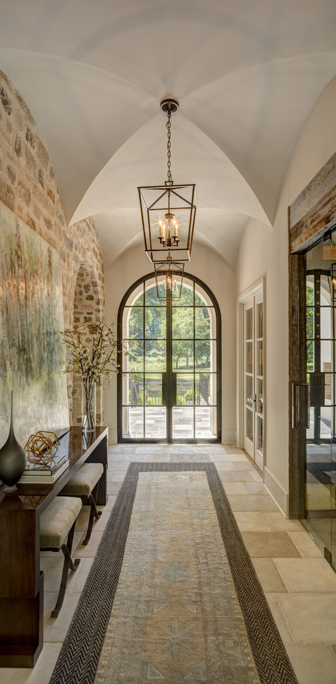 Photo of a traditional entry hall in Charlotte with beige walls, a double front door, a glass front door and beige floor.