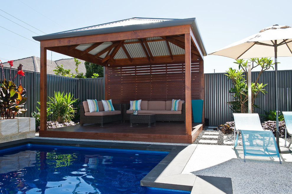 Inspiration for a large tropical backyard patio in Perth with concrete slab.