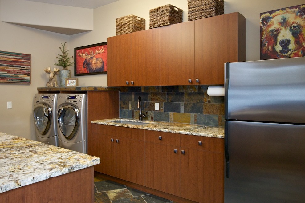Country laundry room in Boise with flat-panel cabinets, medium wood cabinets and a side-by-side washer and dryer.