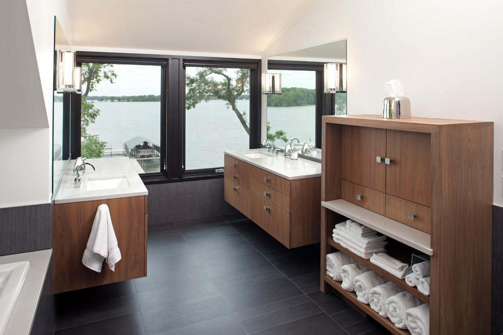 Contemporary master bathroom in Minneapolis with an undermount sink, medium wood cabinets, quartzite benchtops, gray tile, ceramic tile, white walls, ceramic floors, flat-panel cabinets and a drop-in tub.