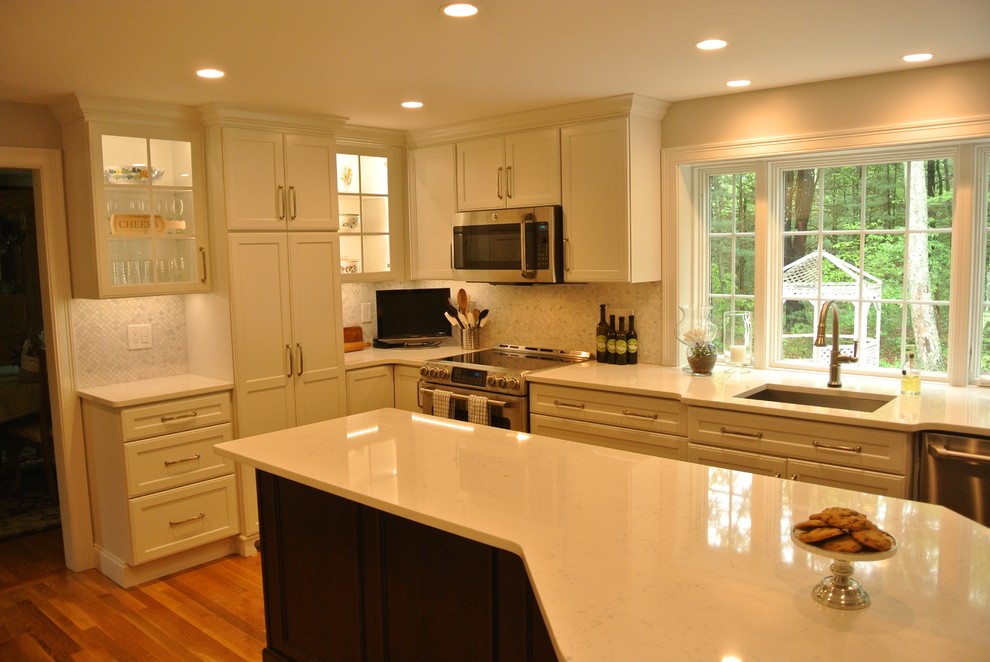 Example of a transitional medium tone wood floor eat-in kitchen design in Boston with an undermount sink, shaker cabinets, quartz countertops, beige backsplash, mosaic tile backsplash, stainless steel appliances, an island and white countertops
