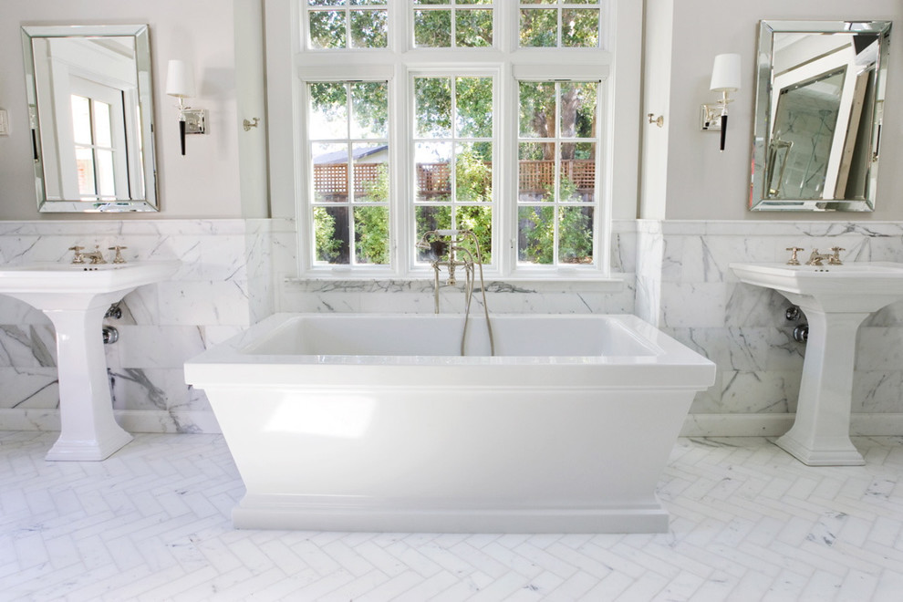 Photo of a traditional bathroom in San Francisco with a freestanding tub, a pedestal sink and subway tile.