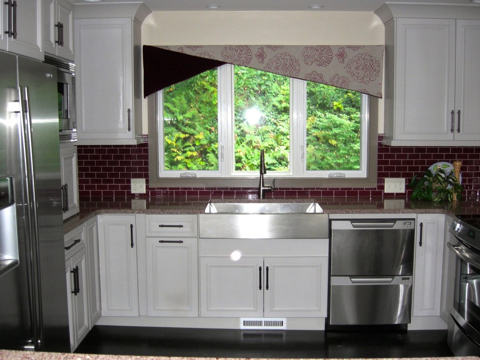 Inspiration for a transitional u-shaped eat-in kitchen remodel in Philadelphia with an undermount sink, recessed-panel cabinets, white cabinets, quartz countertops, glass tile backsplash and stainless steel appliances