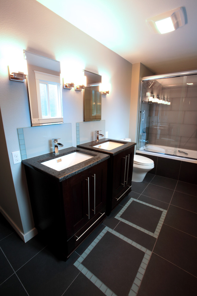 Design ideas for a mid-sized modern master bathroom in Portland with an undermount sink, flat-panel cabinets, brown cabinets, engineered quartz benchtops, an alcove tub, a shower/bathtub combo, a two-piece toilet, gray tile, porcelain tile, blue walls and porcelain floors.