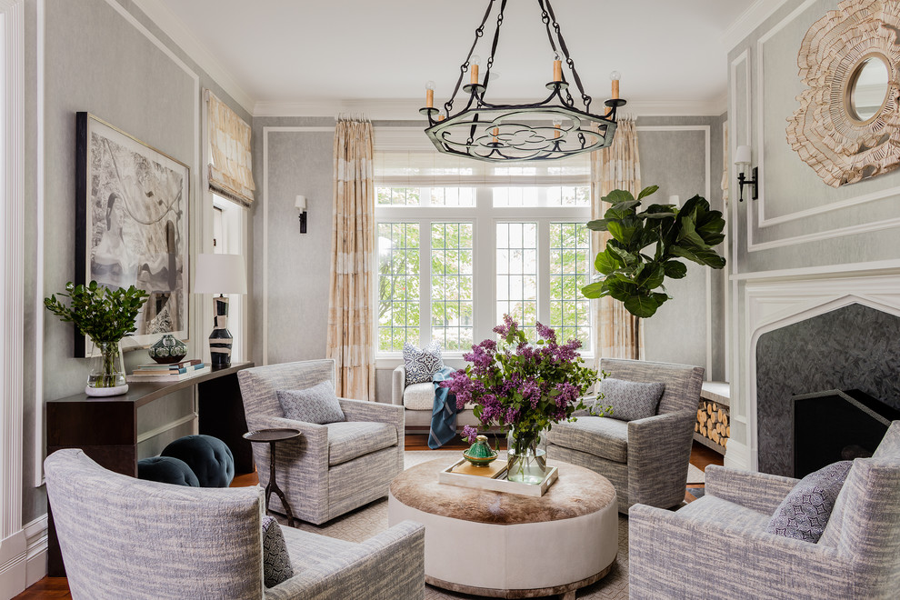 Transitional formal and enclosed medium tone wood floor and brown floor living room photo in Boston with gray walls and a standard fireplace