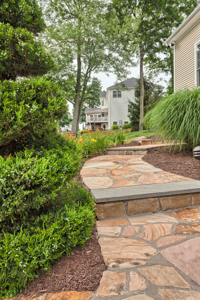 Large traditional side yard garden in New York with a garden path and natural stone pavers.