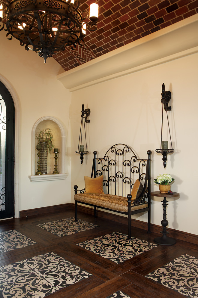 Inspiration for a large mediterranean foyer in Phoenix with beige walls, porcelain floors, a single front door and a black front door.