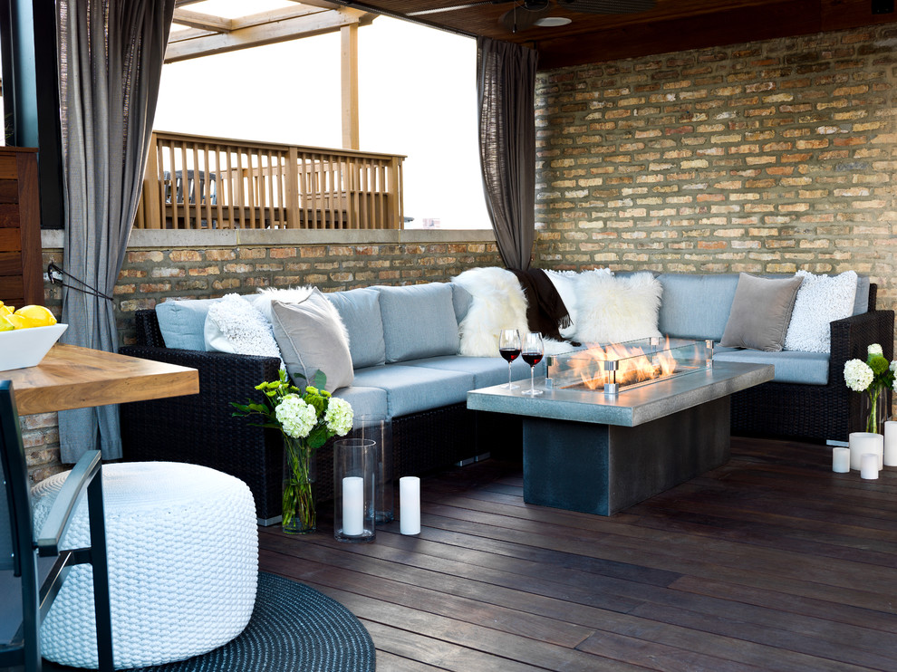 Mid-sized trendy rooftop partial sun deck photo for summer in Chicago with a fire pit and decking