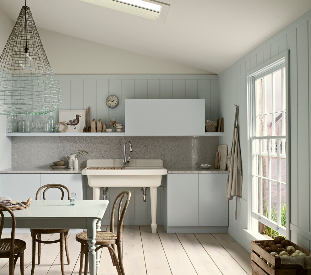 Small country single-wall eat-in kitchen in Philadelphia with a farmhouse sink, flat-panel cabinets, blue cabinets, painted wood floors, no island, laminate benchtops, grey splashback, stone slab splashback and beige floor.