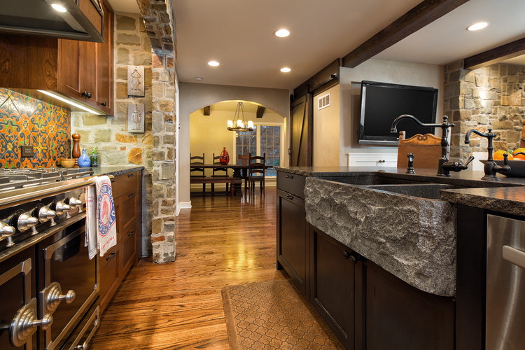 This is an example of a large country single-wall eat-in kitchen in Kansas City with a double-bowl sink, shaker cabinets, medium wood cabinets, terrazzo benchtops, multi-coloured splashback, cement tile splashback, stainless steel appliances, medium hardwood floors and with island.