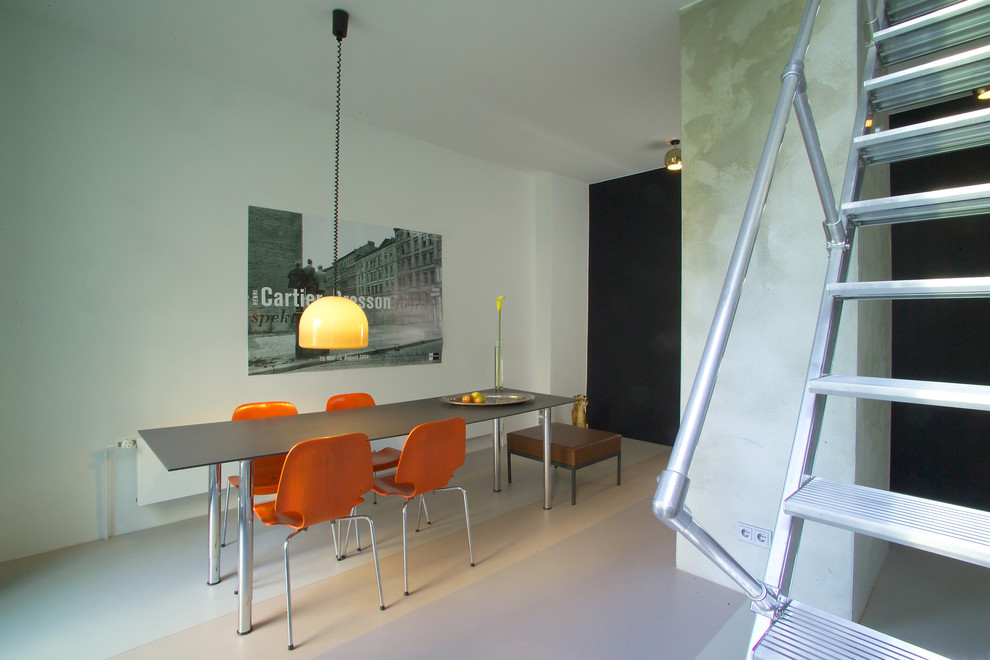 Photo of a mid-sized industrial open plan dining in Berlin with white walls, linoleum floors, no fireplace and multi-coloured floor.