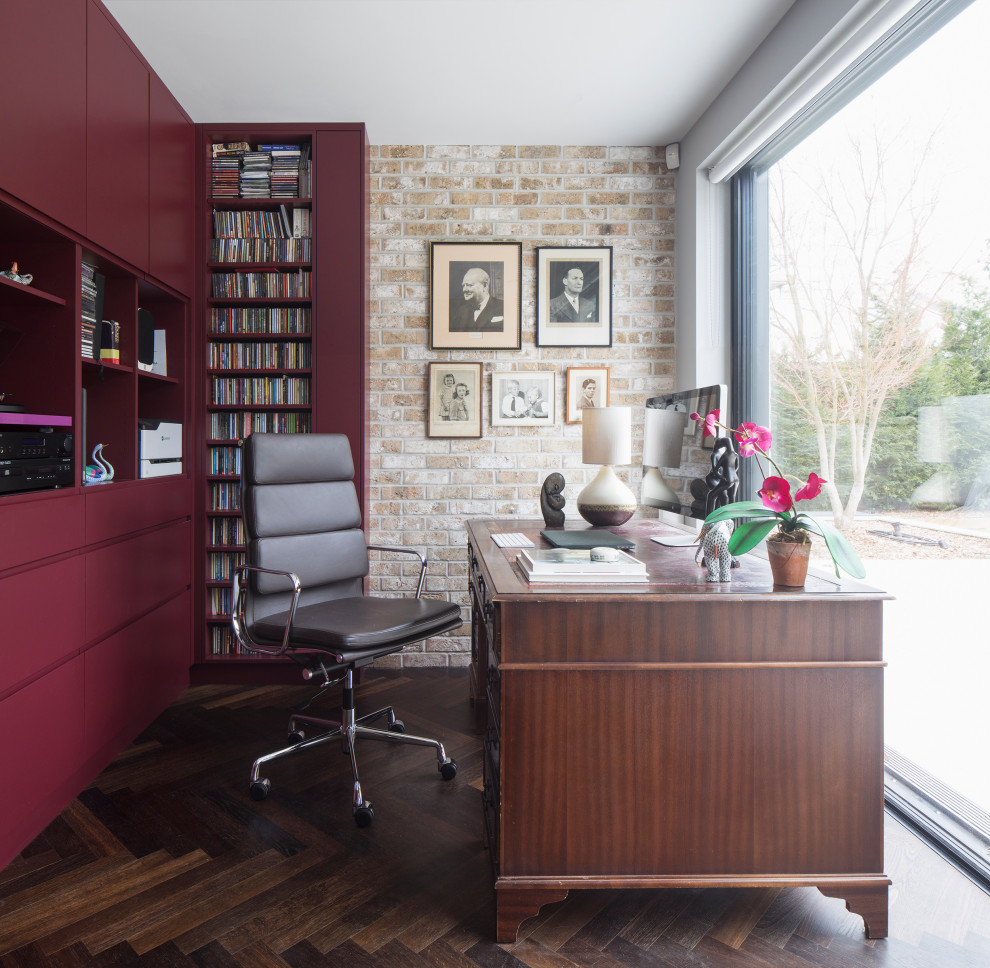 This is an example of a contemporary home office in London with a feature wall.