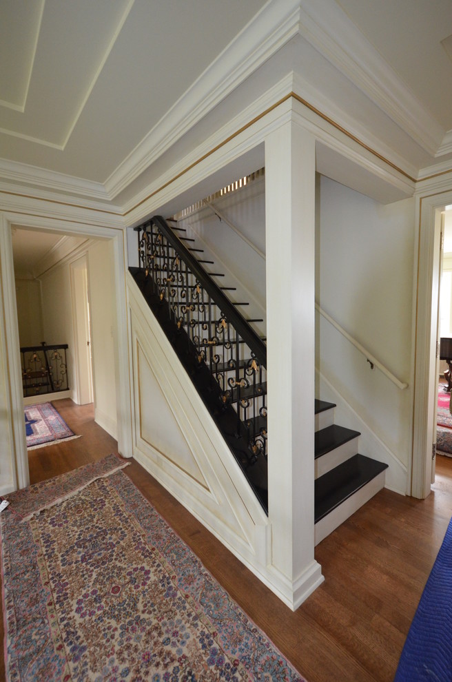 This is an example of a mid-sized traditional wood straight staircase in Seattle with wood risers.