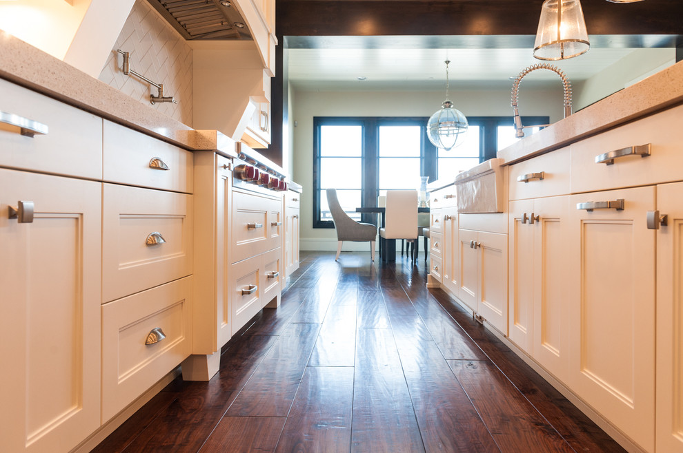 Design ideas for a large transitional single-wall kitchen in Salt Lake City with a farmhouse sink, shaker cabinets, white cabinets, dark hardwood floors and with island.