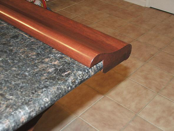 Chicago bar rail fastened to granite