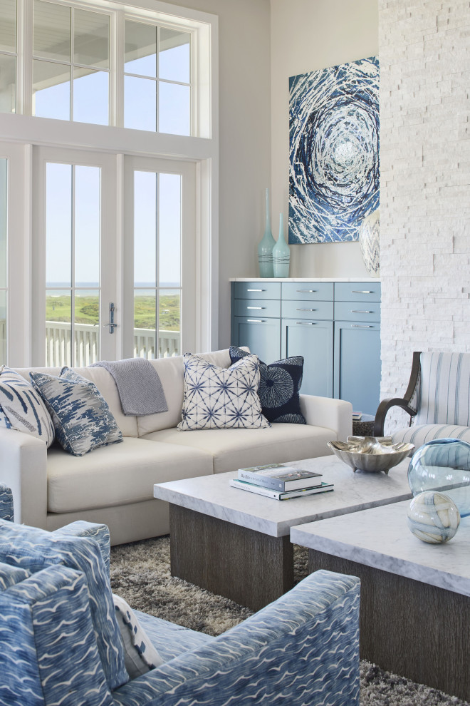 Huge beach style open concept vinyl floor, brown floor and exposed beam family room photo in Other with gray walls, a ribbon fireplace, a stacked stone fireplace and a wall-mounted tv