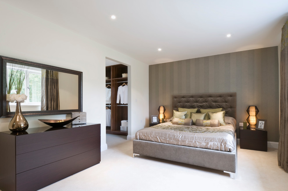 This is an example of a mid-sized contemporary master bedroom in Buckinghamshire with carpet, beige floor and grey walls.