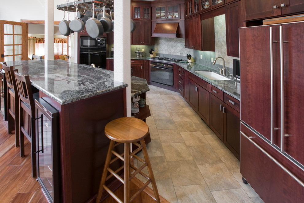 Open concept kitchen - large transitional l-shaped porcelain tile open concept kitchen idea in Denver with an undermount sink, shaker cabinets, red cabinets, granite countertops, gray backsplash, stone tile backsplash, black appliances and an island