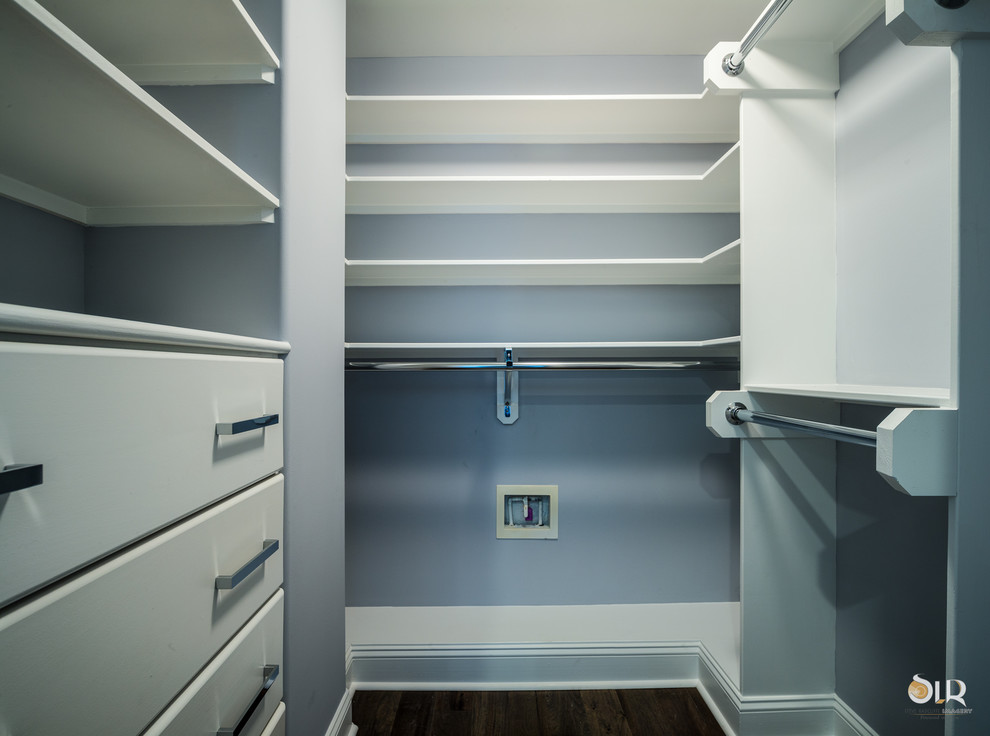 Example of a transitional gender-neutral dark wood floor and brown floor walk-in closet design with open cabinets and white cabinets